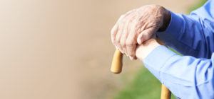 Picture of Elderly Persons hands on a Wood Cane