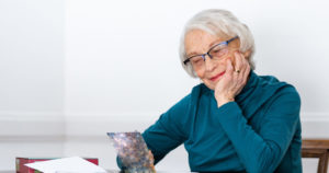 Elderly woman reading a card